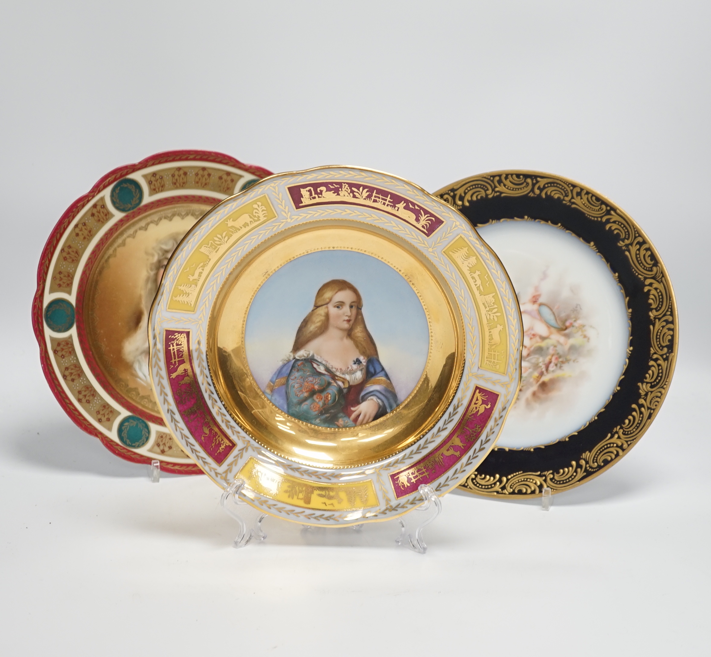 Two early 20th century Vienna style cabinet plates painted and enamelled with portraits and a Sevres style cabinet plate, 24cm (3)